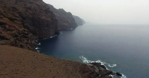 Low pass flight over cliff Stock Footage 58316312