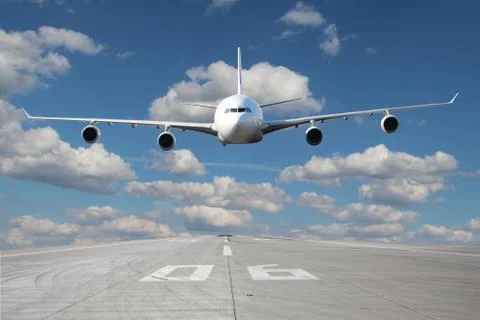 Low pass of white plane Stock-Fotos