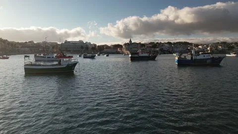 Low perspective POV view flying between fishing boats at sunset in Cascais Bay Stock Footage 202746195