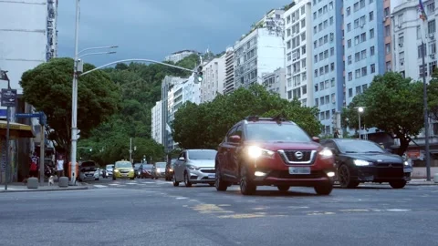 Low perspective view of heavy vehicle traffic and pedestrians in Rio Stock Footage 261111148