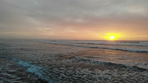 Low Pull Back over Surf and Wet Sandy Beach, Sunset Video stock 145235972
