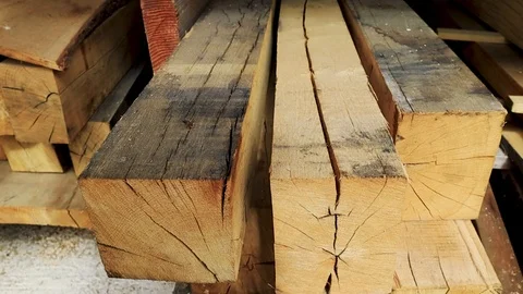 Low pull back of stacked planks of wood in a joinery yard Stockbeeldmateriaal 93798302