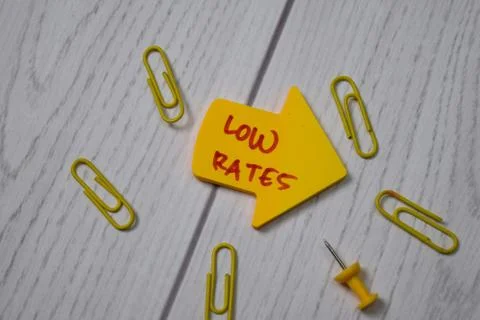 Low Rates write on sticky note isolated on wooden table. 写真素材