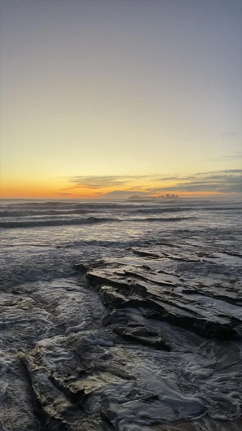 Low Rocky Shoreline with Waves Breaking in Morning Light Vidéo 301654099
