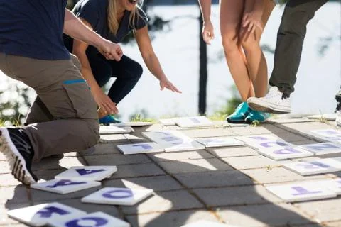 Low Section Of Business Team Solving Crossword Stock Photos