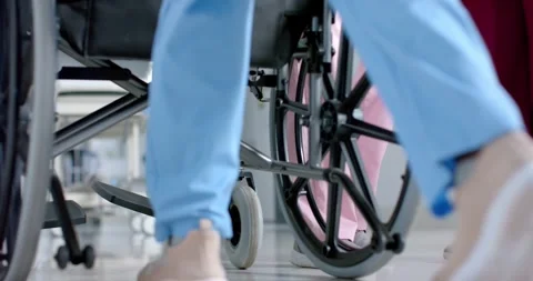 Low section of diverse doctors walking in corridor at hospital, slow motion Stock Footage 337399529