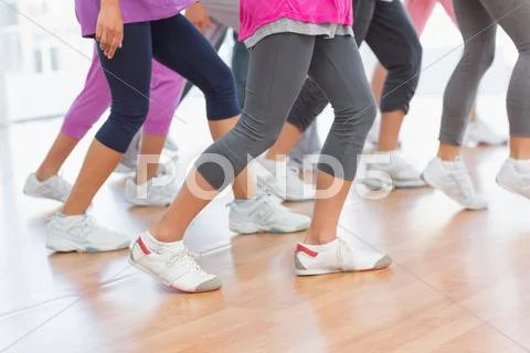 Low section of fitness class doing pilates exercise Stock Photos