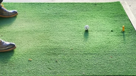 Low Section of a Golfer Hitting the Golf Ball on the Mat on Driving Range Stock-Footage 224887555