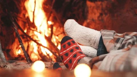 Low section legs of husband and wife covered in socks and warm blanket relaxing  Stock Footage 166244575