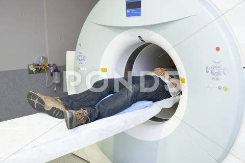 Low Section Of Male Patient Lying In Mri Scanner
