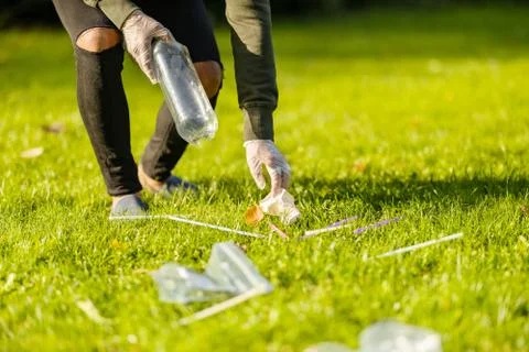 Low section of man cleaning park on sunny day Stock Photos