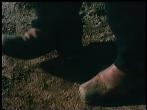 Low section of man crushing pocket watch with the heel of his boot Video stock 260254994