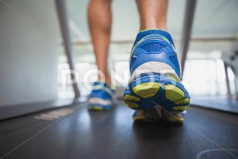 Low section of a man running on treadmill Stock Photos