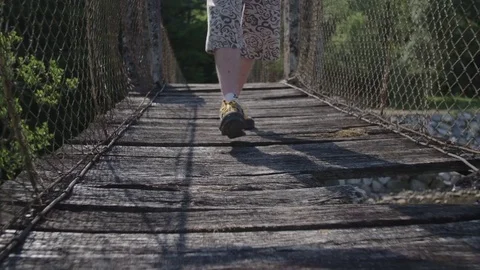 Low section of man walking on a wooden bridge Stockbeeldmateriaal 76739360