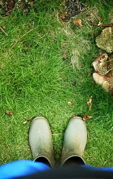 Low section man wearing rubber boots in the garden Stock Photos