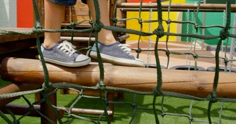 Low section of mixed-race schoolgirl playing in school playground on a sunny day Stock Footage 106947901