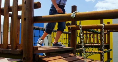 Low section of mixed-race schoolgirl playing in school playground on a sunny day Stock Footage 106947989
