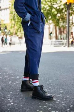 Low section vertical of man in blue trousers and black boots Stock Photos