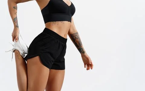 Low section view of fit young woman stretching her leg before a run in fitness Stock Photos