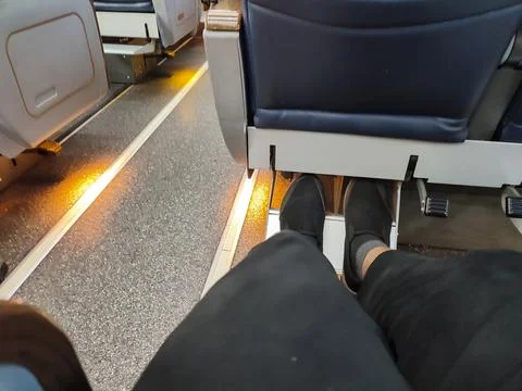 Low section view of passenger sitting on train seat during travel Stock Photos