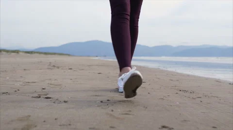 Low section of woman's feet walking on beach Stock Footage 59081469