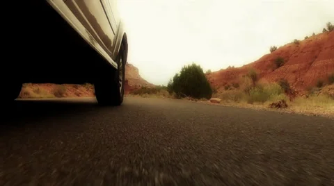 Low shot of car in desert Stock Footage 29633436