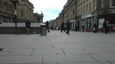 Low shot as crowds cross city centre square, shoppers and elegant buildings Stock Footage 1099509