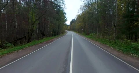Low shot from drone over empty road with climb up Stock Footage 205239721