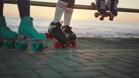 Low shot of Four friends with rollerskates on Stock Footage 279336257