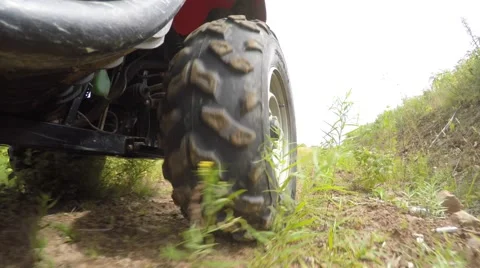Low shot of a four wheeler side by side tire driving on dirt Stock Footage 54127409