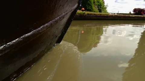 Low Shot of a Narrowboat Steering Down a River Stock Footage 56146997