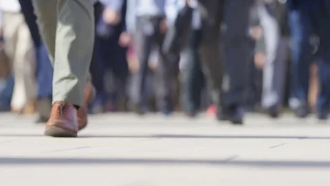 Low shot of pedestrian commuters walking to work in the morning rush, in slow mo Stock Footage 77610058