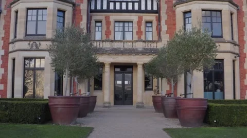 Low shot pulling out from front door of Victorian mansion Wood Norton Hall near 스톡 동영상 284249575