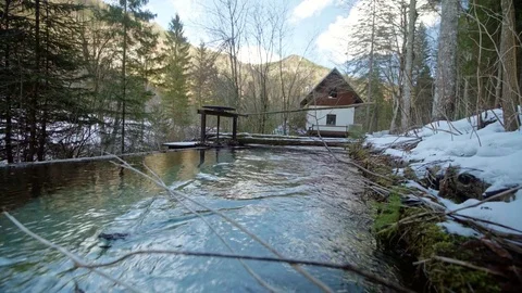Low shot of a river flowing to a small hydro powerplant Video stock 85062294