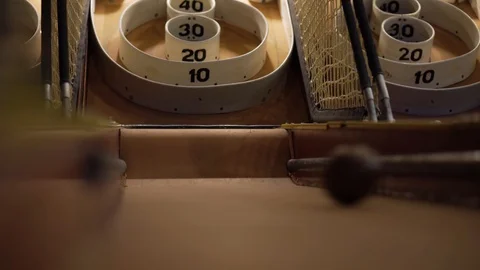 Low shot of a skee-ball rolling down the ramp. Stock Footage 93239482