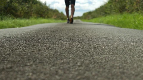 Low Shot Walking Toward Camera On Road 4K Slow Motion Stock Footage 214296493
