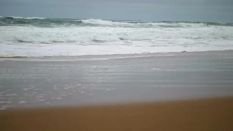 Low shot of waves breaking on shore Stock Footage 274345340