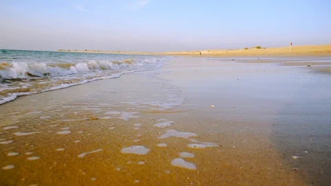 Low shot of waves crashing into the sandy shivrajpur beach dwarka gujarat Stock Footage 101095886