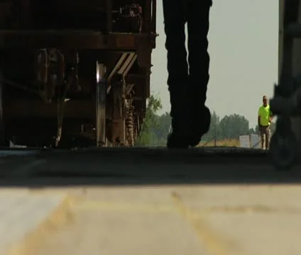 Low shot of workers walking next to train Stock Footage 21590718