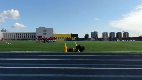 Low side drone flight across stadium field Video stock 333358990