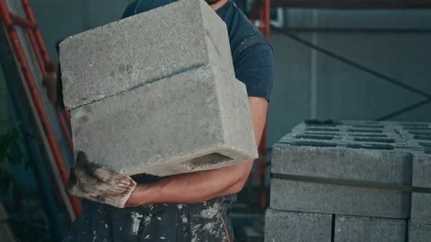 Low-skilled construction labor. A man works as a loader and carries heavy Stock Footage 253694314
