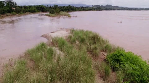 Low slow flying view of a land patch in the river 스톡 동영상 329935698
