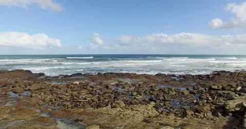 Low, slow forward flight over a rocky coastline - 4K Drone Footage Stock Footage
