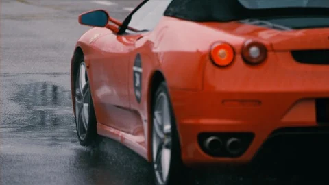 Low slow motion shot of red sports car driving by Stock Footage 101817892