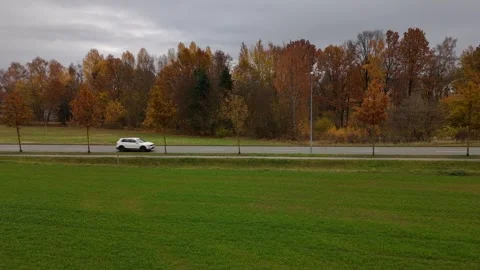 Low Smooth Drone Flight Along Autumn Road with Cars Stock Footage 321288417