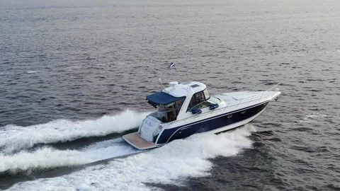 Low, smooth, tracked from the rear right side of luxury speed boat Stock Footage 113964011