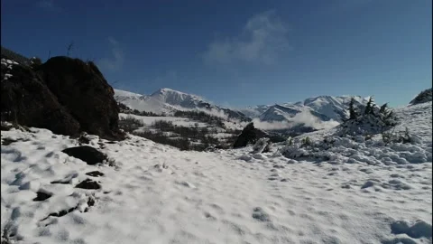 Low snow flight to standalone rock - 1080p Stock Footage 164101647