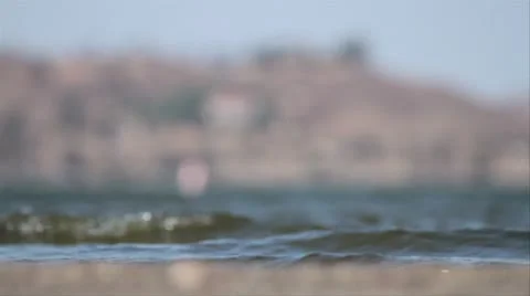 Low static shot of water breaking on lake shore Stock Footage 8958978