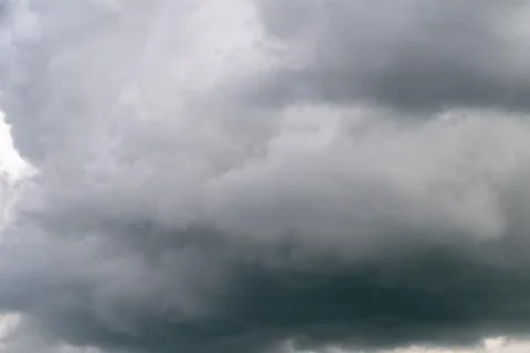 Low storm ceiling hovering overhead ready to burst, compact dark base with .. Stock Photos
