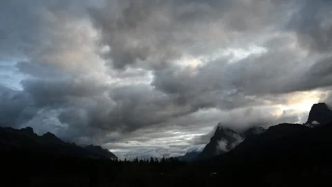 Low storm clouds churn and race across the sky in a moody time-lapse, drifting Stock Footage 329072117